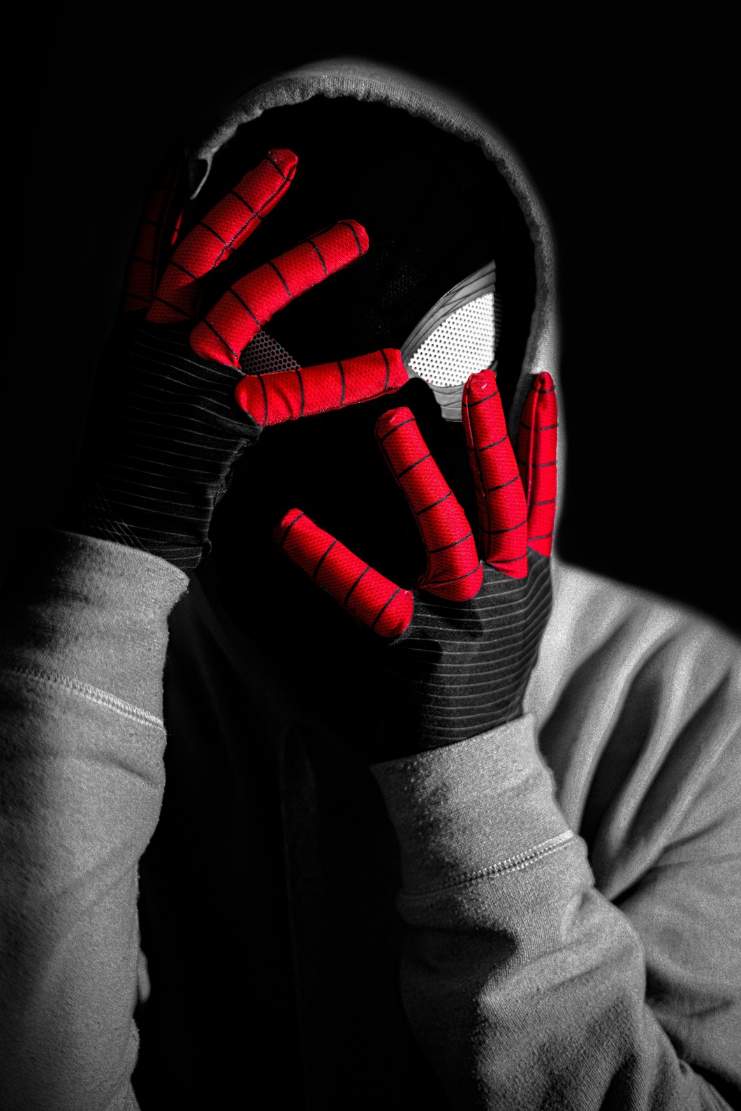 a person wearing a spider - man mask covering their face
